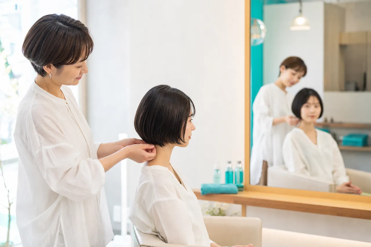 美容室でお客様のうなじ・襟足を鏡で確認する美容師